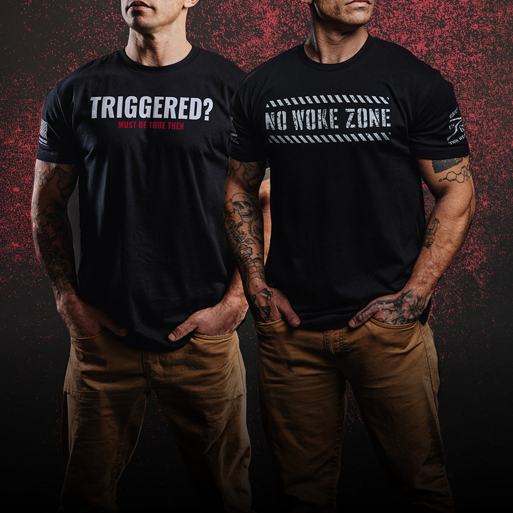 Two men wearing black graphic t-shirts with white and red text, standing against a dark textured background. The shirt on the left reads 'TRIGGERED? MUST BE TRUE THEN' and the shirt on the right reads 'NO WOKE ZONE' with a white striped banner graphic.