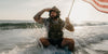 Man on surf board holding American Flag