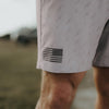 Close-up of a person wearing shorts with an American flag design.
