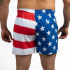 American flag-themed swim shorts on a plain background