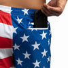 Person wearing American flag patterned shorts with a phone in the pocket.