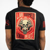 Black t-shirt with a graphic design featuring a skull and text on the back, worn by a person.