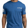 Blue t-shirt with '1776' printed on it, worn by a person.