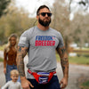 Man wearing a 'Freedom Breeder' t-shirt with a woman and child in the background.
