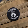 Skull and crossbones patch with text on a tactical vest