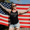 Person wearing a tank top with 'STILL NOT BRITISH!' text in front of an American flag.