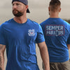 Man wearing a blue t-shirt with a logo on the front and 'Semper Paratus' on the back.
