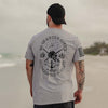 Man wearing a gray t-shirt with a design on the beach
