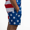Person wearing shorts with a red, white, and blue pattern on a white background
