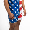 Person wearing American flag patterned shorts on a white background