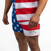 Person wearing American flag patterned shorts on a white background