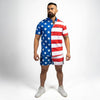 Man wearing a dress with an American flag design on a plain background