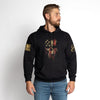 Man wearing a black hoodie with a graphic design on a white background