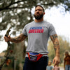 Man wearing a 'Freedom Breeder' t-shirt outdoors with trees in the background