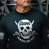 A man wearing a black long-sleeve t-shirt with a distressed silver graphic of a skull and crossed bones, featuring the text 'THE GOONS' and 'ALWAYS SAY KILL'.