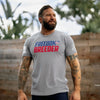 Man wearing a gray t-shirt with 'Freedom Breeder' text, standing outdoors.