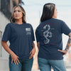 Two women wearing navy blue t-shirts with different designs on the front and back.