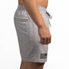 Gray shorts with a subtle pattern and American flag design on a white background