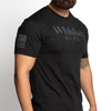 Person wearing a black t-shirt with 'Whiskey Helps' text on a white background