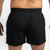Black shorts worn by a person on a white background