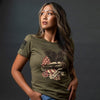 Woman wearing a green t-shirt with a graphic design on a dark background