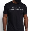 Black t-shirt with 'NOT IN THE FILES' text worn by a person on a white background