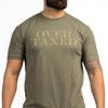 Person wearing a green t-shirt with 'OVER TAXED' text on a white background