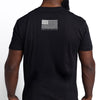 Black t-shirt with American flag design on the back, worn by a person.