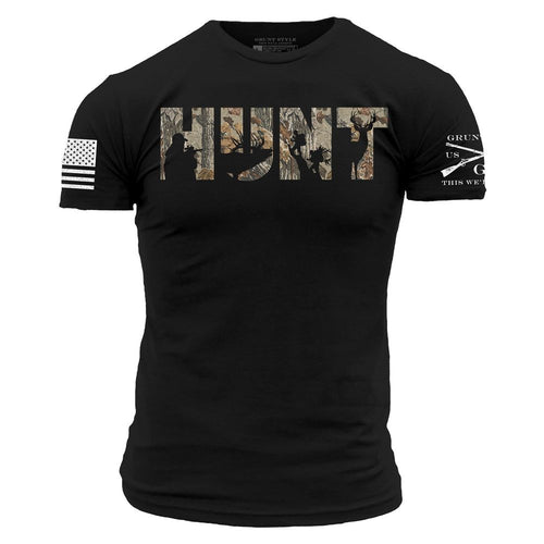 A black short-sleeve t-shirt with the text 'CAN'T FIX STUPID' printed in white across the chest. The left sleeve features a distressed white American flag graphic, and the right sleeve has a white graphic with crossed rifles and the text 'GRUNGER USA THIS WEEK'.
