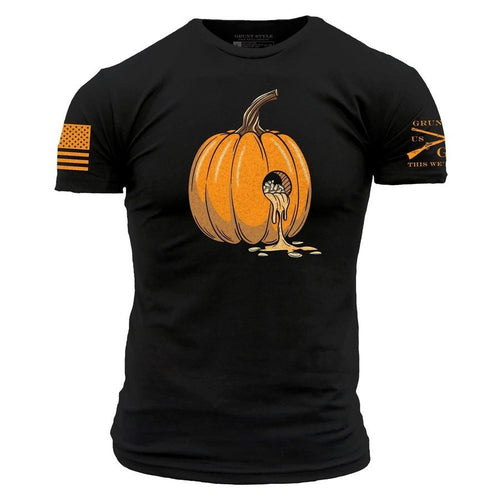 A black short-sleeve t-shirt with a graphic of an orange pumpkin on the chest, with a small skull inside the pumpkin and orange dripping details. The left sleeve features a distressed orange American flag, and the right sleeve has orange text and crossed rifles.