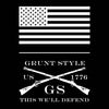 A black square graphic with a white American flag at the top, crossed flintlock-style rifles in the center, and the text 'GRUNT STYLE US 1776 GS THIS WE'LL DEFEND' in white.