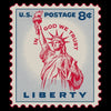U.S. postage stamp with Statue of Liberty and 'In God We Trust' text