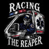 A black graphic print featuring a skeletal driver in a blue EMS uniform sitting inside a white ambulance with red lights, with the words 'RACING THE REAPER' in distressed white lettering above and below.
