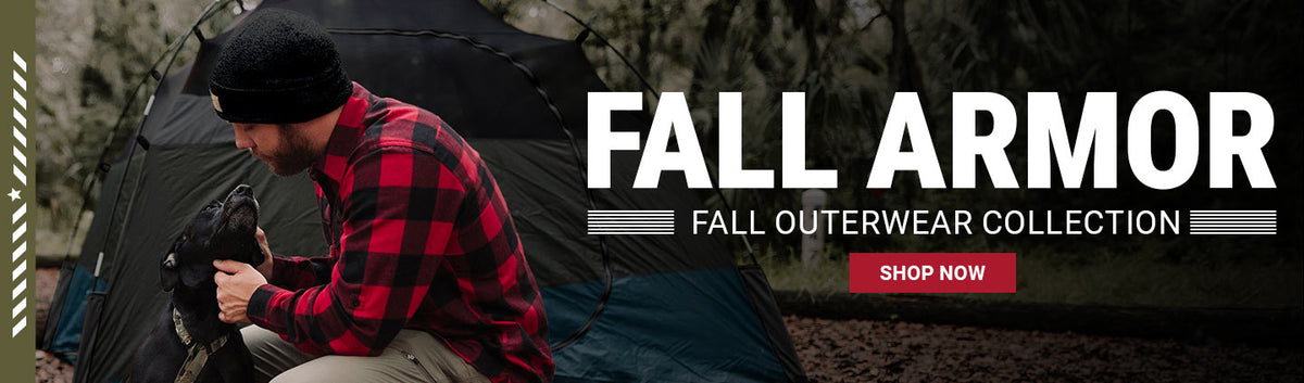 Fall Armor: Fall Outerwear Collection – man in a red plaid flannel crouching with a black dog by a tent