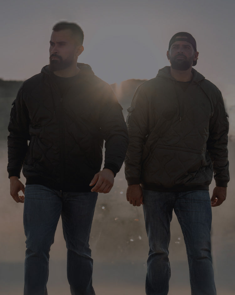 Two men walking together with a blurred background