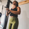 Woman wearing the military green high waisted fitness leggings on leg day